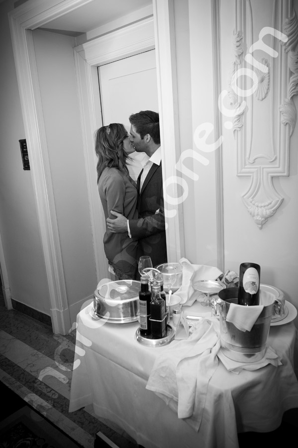 Kissing in black and white inside Hotel Regis