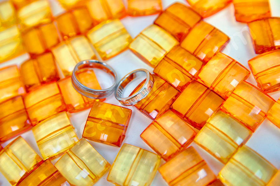 The luxurious wedding rings set on orange background