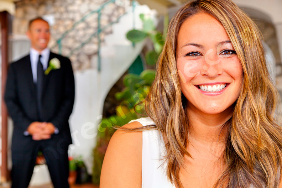 Wedding bride looking through the photographer's camera