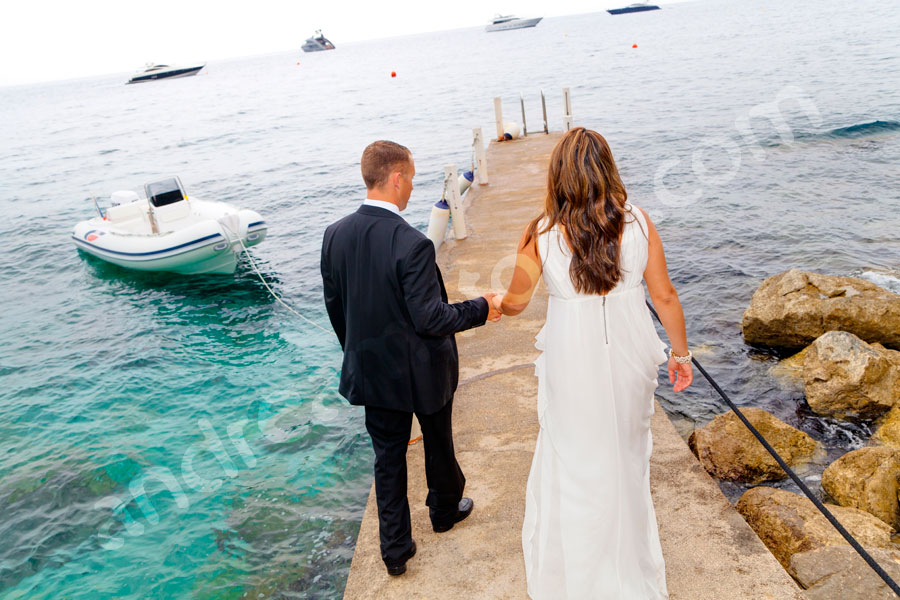 Wedding husband and wife just married on a jetty in Italian Capri 