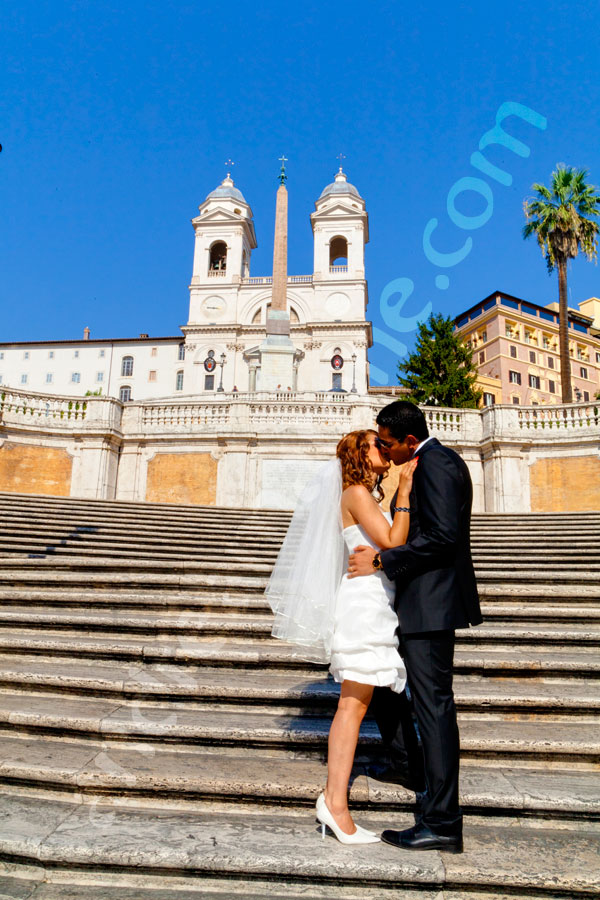 Couple just married kissing on Scalinata Trinita' dei Monti by Piazza di Spagna