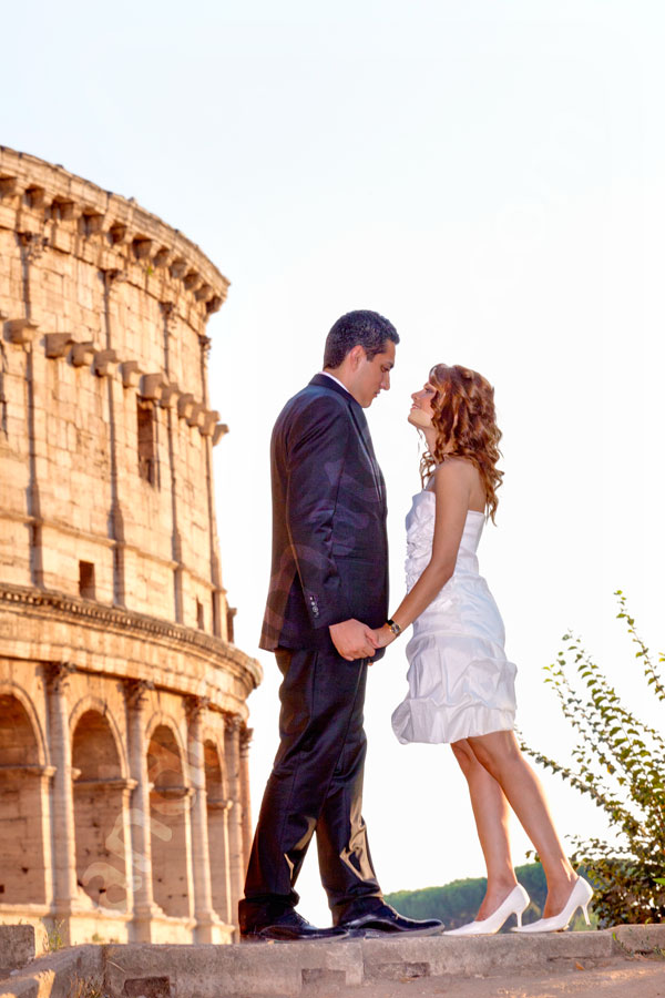 A romantic couple at sunset by the Roman Coliseum  
