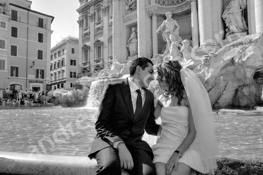 Bride and groom romantically kissing by Fontana di Trevi in Black and White photography 