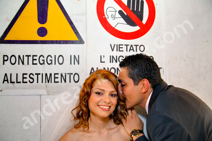 The bride and groom behind Italian construction signs 