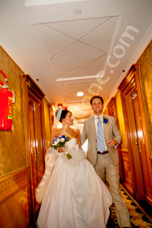 Newlyweds walking together in a hotel corridor heading to get married