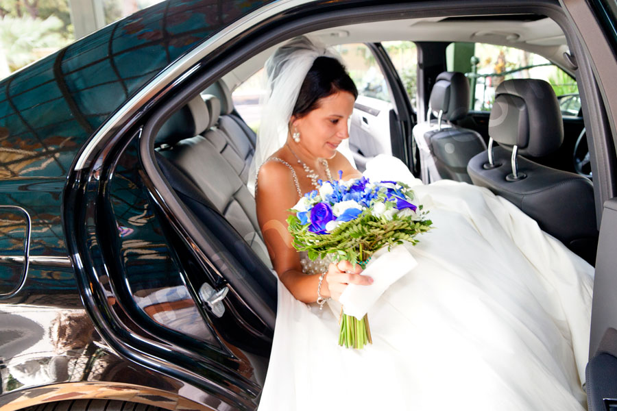 The bride entering the car 