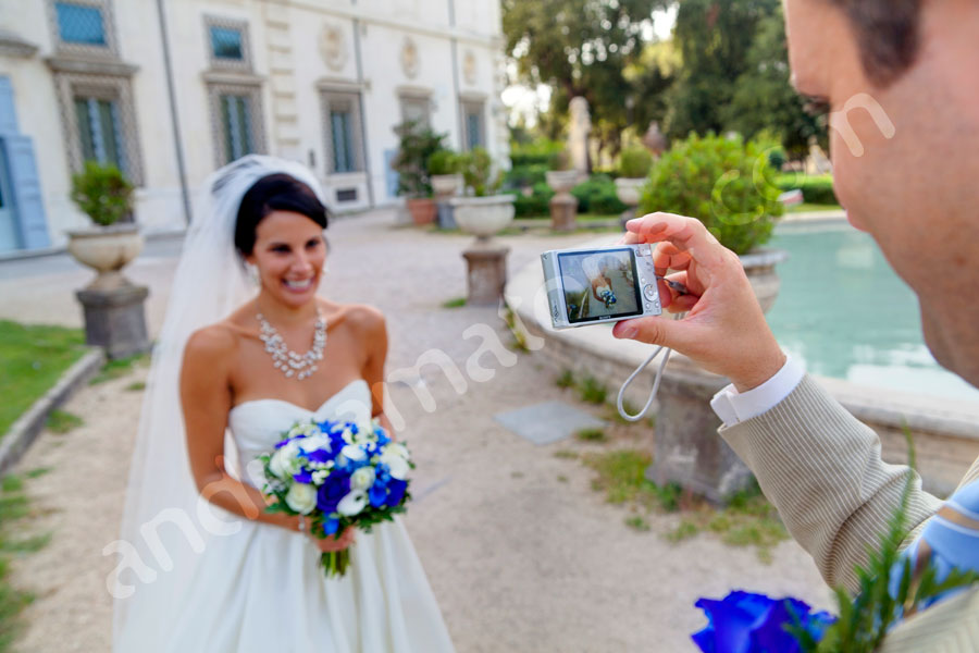 The groom photographer as he is taking a picture of the bride