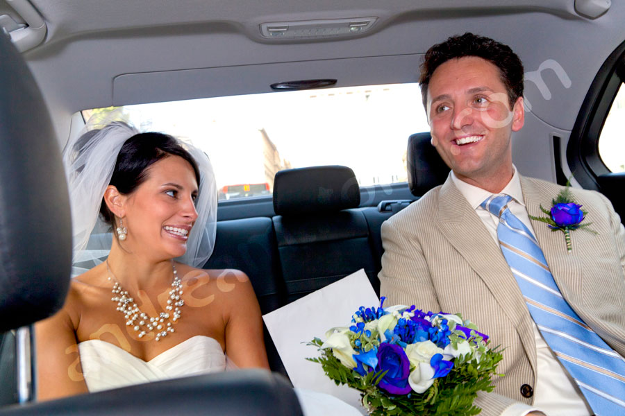 Happily inside the wedding car 