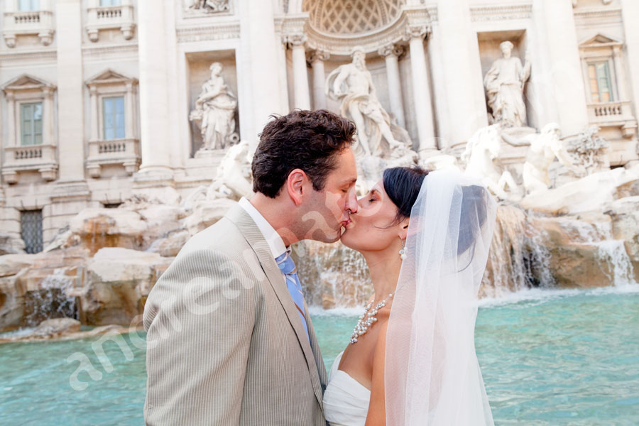 Man and woman just married kissing at Fontana di Trevi