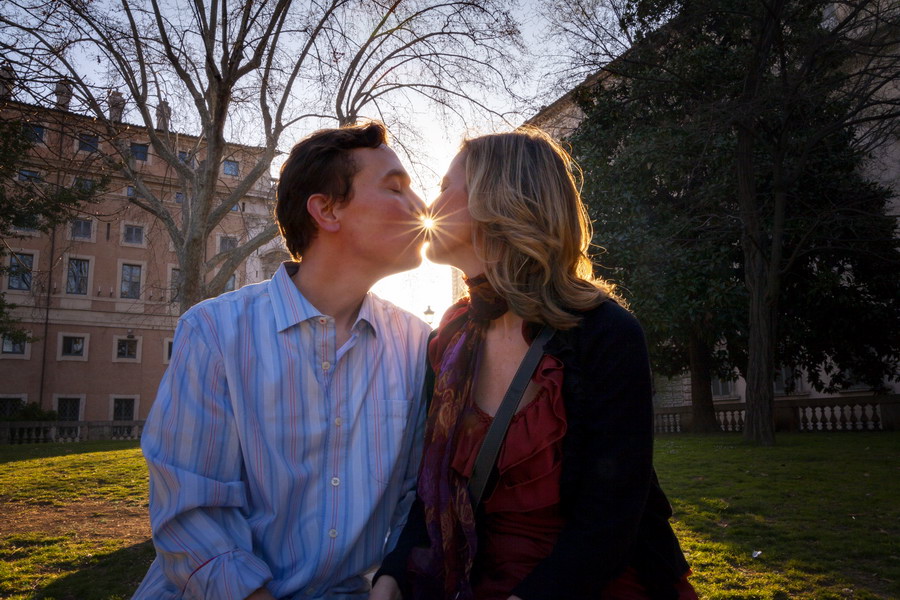 Kissing at sunset in Italy. Engagement photographer Rome.