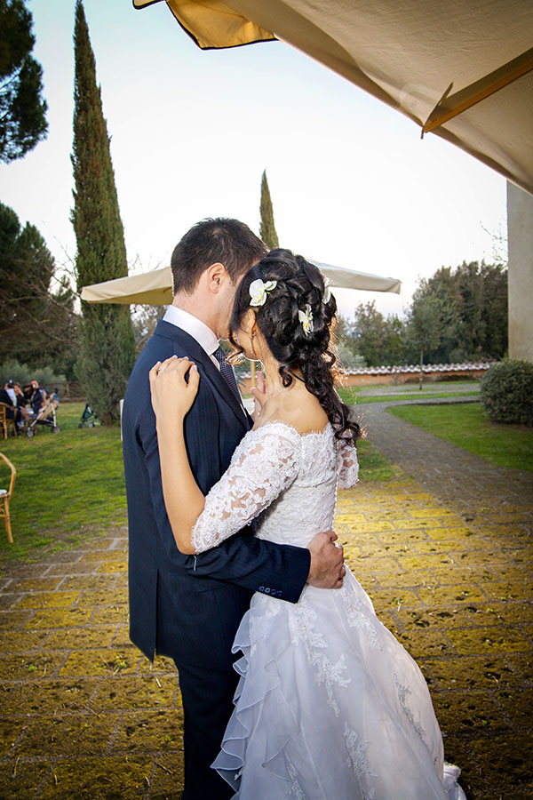 Bride and groom romantically dancing together at the wedding party 