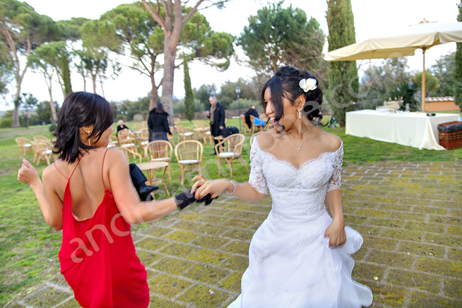 Bride and friends dancing together at the evening party 