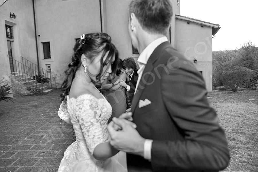 Bride and groom dancing together in black and white pictures 