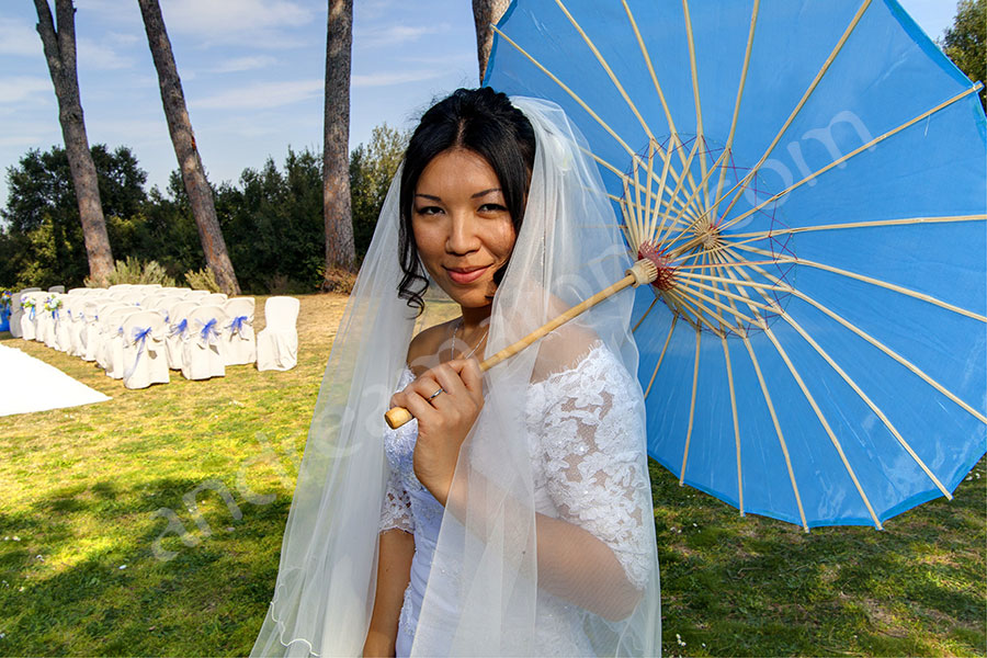 Beautiful picture of the bride holding a blue sun umbrella 