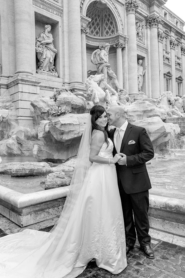 Newlyweds in Piazza Fonanta di Trevi during. Black and white image. 