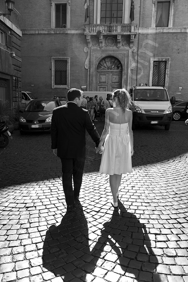 Black and white image as the couple walks away on sampietrini