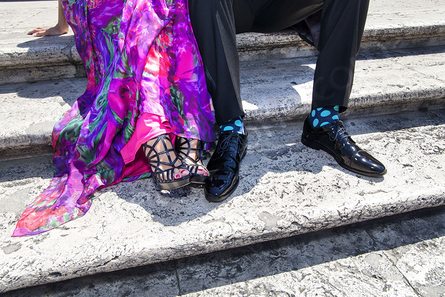 Couple's feet and legs. Extravagant look.