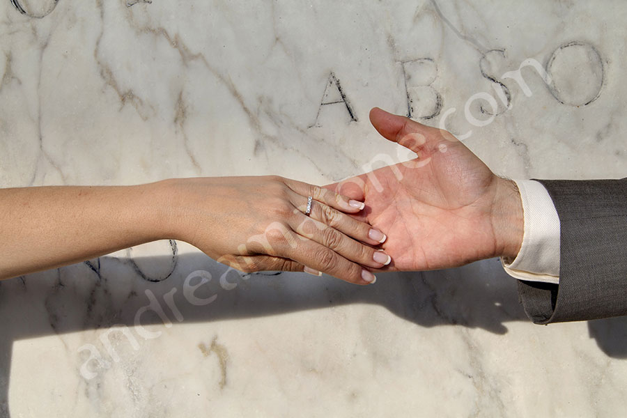 Couple just married holding hands showing their matrimonial rings 