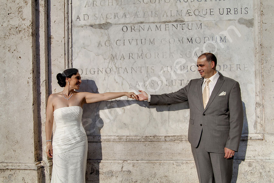 Bride and groom and their gesture in Piazza di Spagna