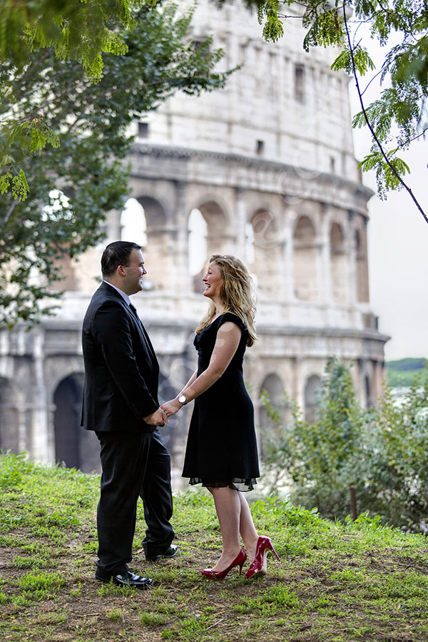 A honeymoon session posing standing before the Colosseum.