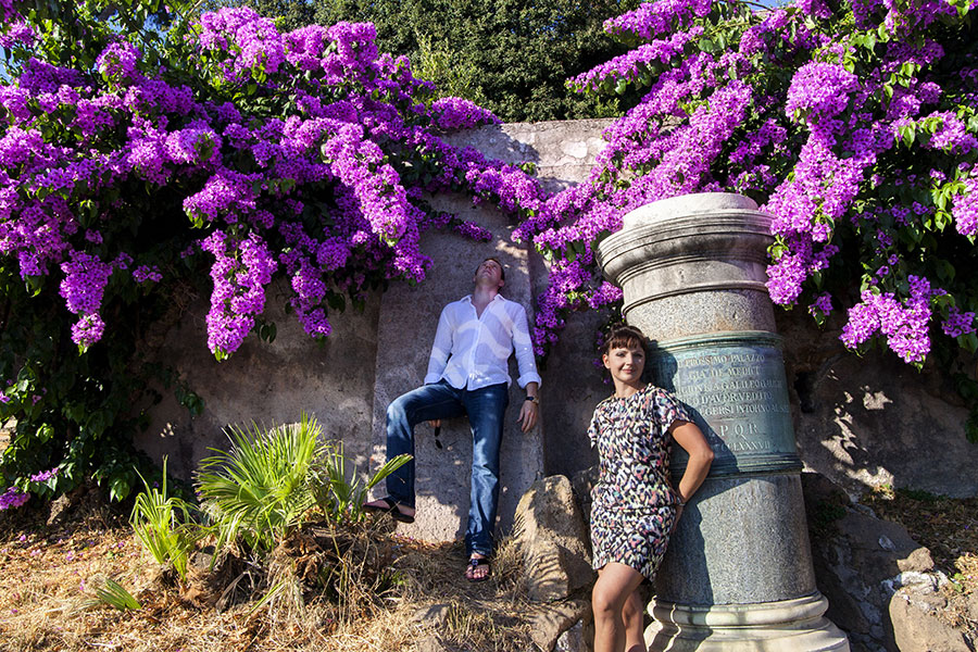 Posing for a photographer picture by purple flowers.