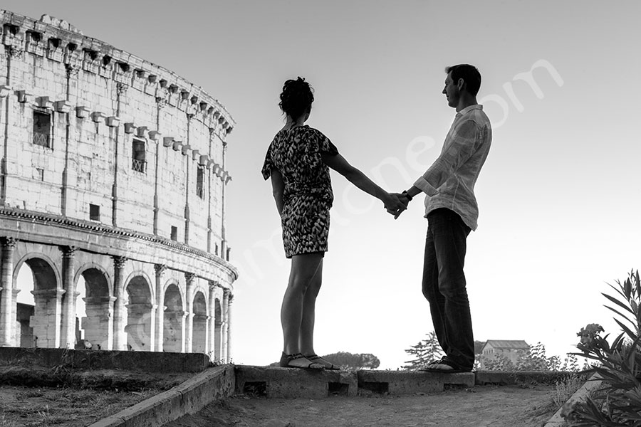 Standing in front of the Roman Coliseum looking away. Black and white picture. 