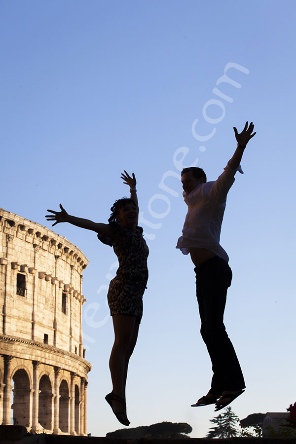 Best engagement photographers in Rome Italy. Couple jumping in front of the Roman Colosseum