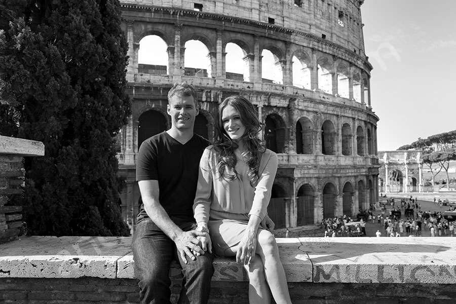 Sitting in front of the Colosseum admiring the view.