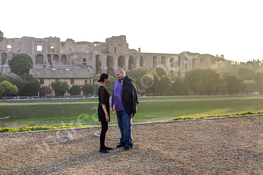 Couple standing on top of Circo Massimo in the roman city.