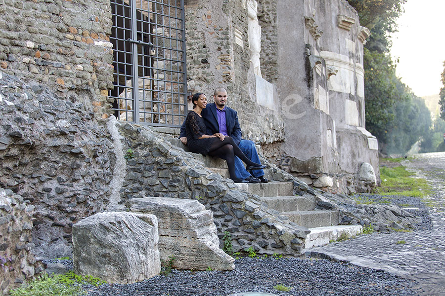 Couple sitting down and relaxing during a picture session in Italy on ancient Appia