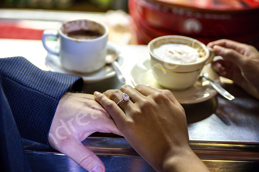 Engagement ring during a coffee break holding hand together. 