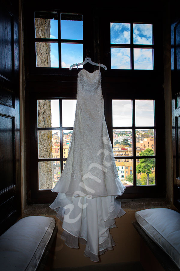 The bridal dress photographed hanging from a window Castle Odescalchi Italy