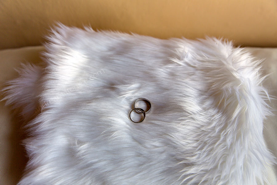 Matrimonial rings photographed on a soft furry white cushion