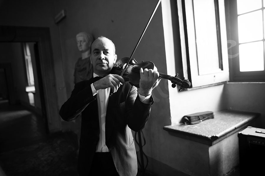 The violin player playing music as the party enters.