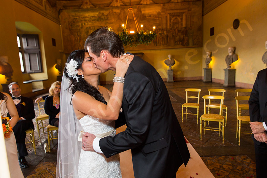 Bride and groom kiss during the wedding ceremony