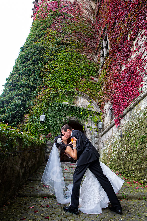 Wedding couple kissing in front of Odescalchi Castle in Italy