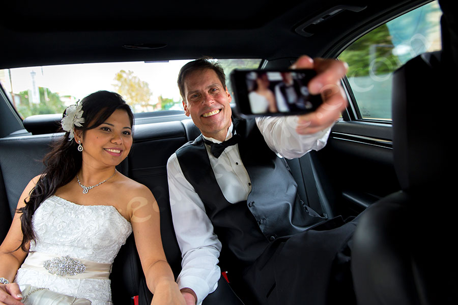 Bride and groom photographer taking a picture of themselves