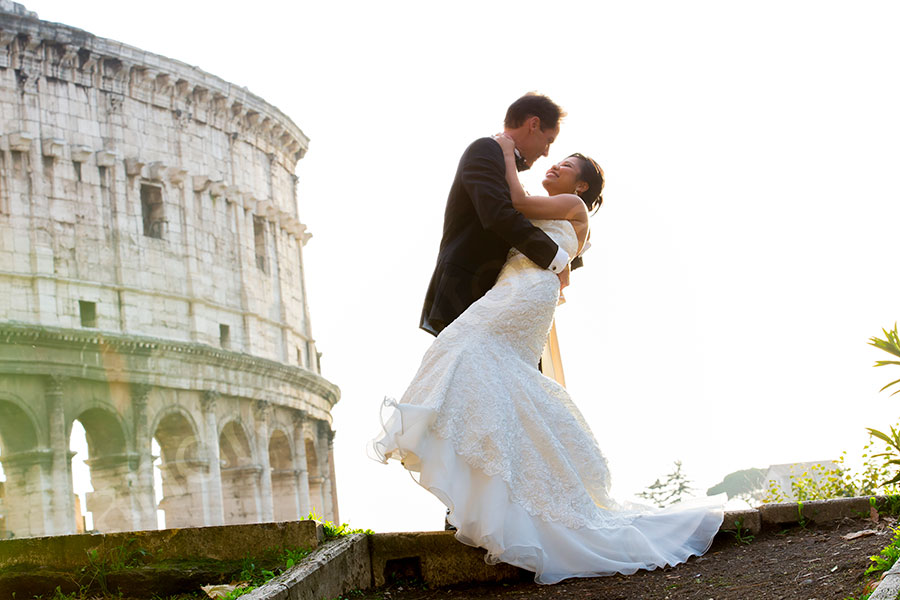 Bride and groom together the roman Colosseum in Rome