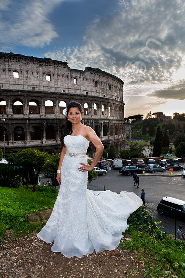 Bride posing for the photographer before the Colosseum in Rome Italy