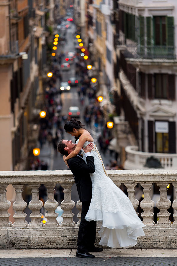 Groom lifting the bride up at the Spanish steps in Rome Italy