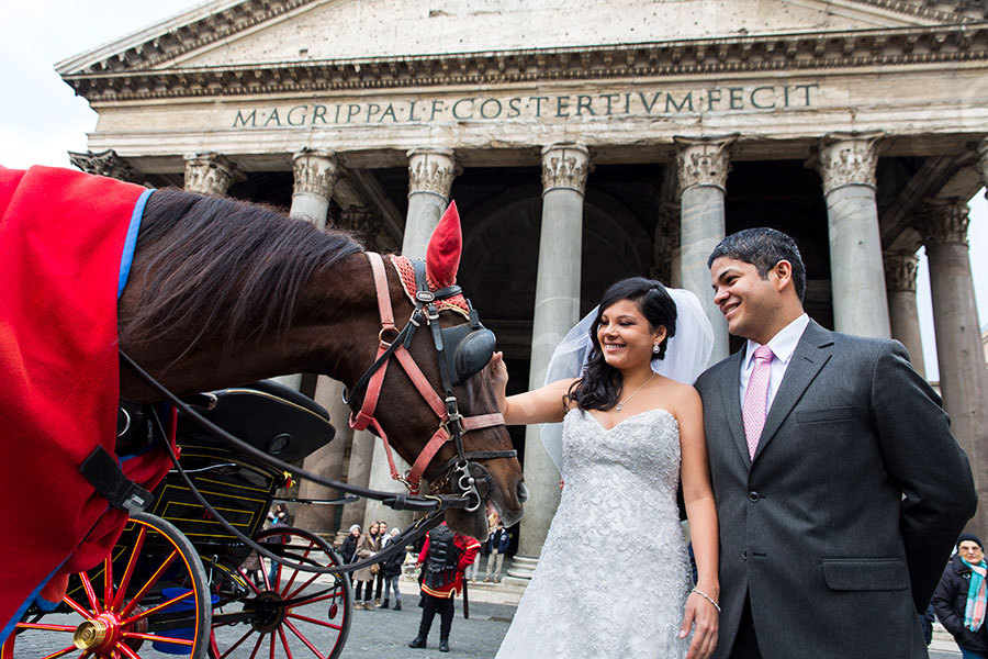 Newlyweds petting a horse at the Pantheon.