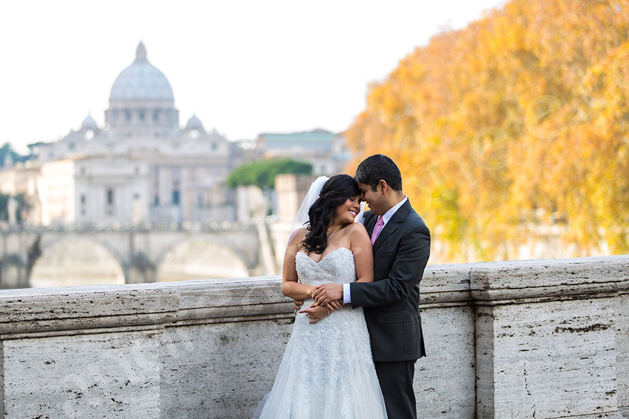 Romantic picture of a newlywed couple in front of Saint Peter's square in the Vatican city.