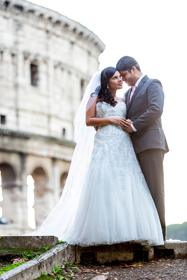 Newlyweds posing in front of the Colosseum.