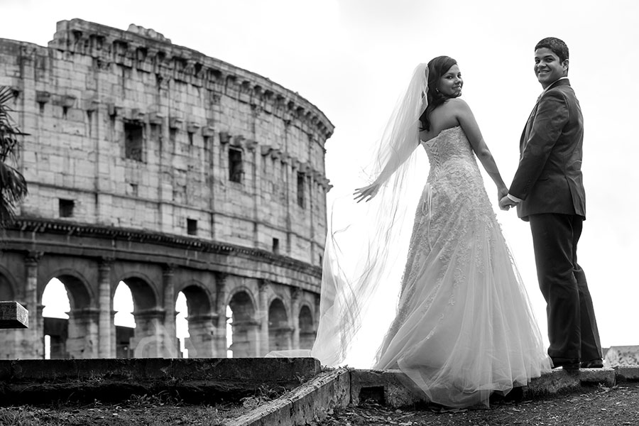 Colosseum in black and white picture. Bride and groom posing.