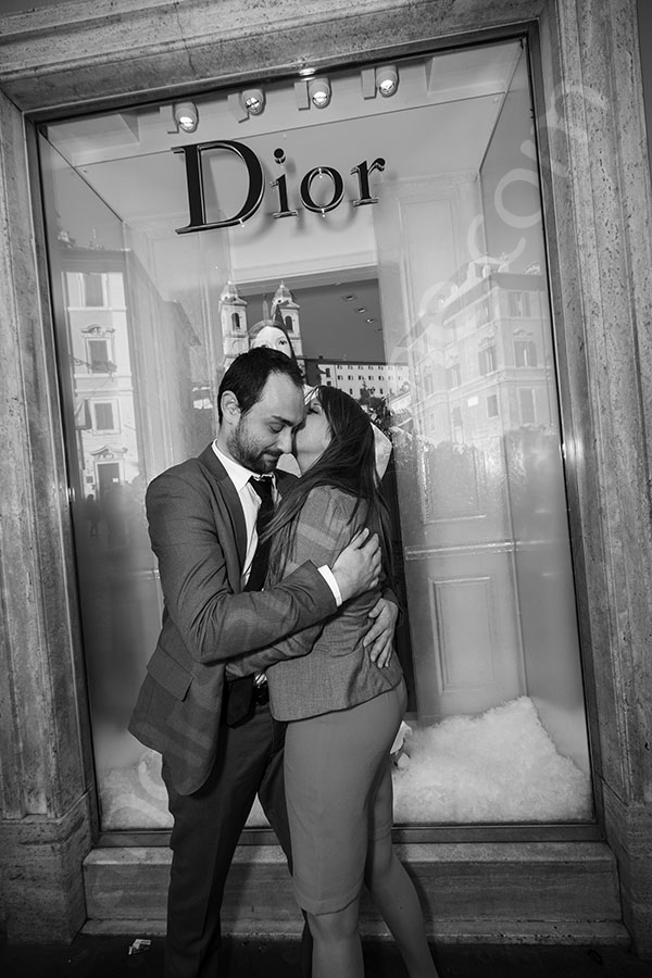 Couple in love in front of the Dior showcase