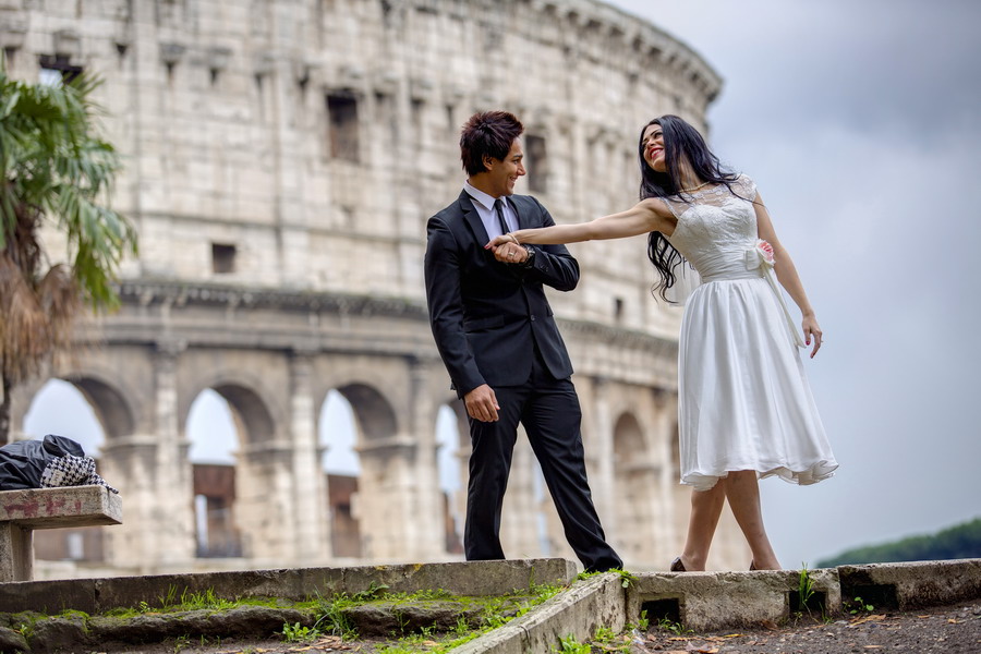 Wedding couple having fun at the roman coliseum in Rome Italy