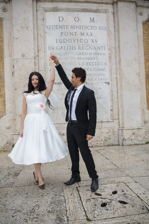 The groom spins the bride around at the Spanish steps in Rome black and white version