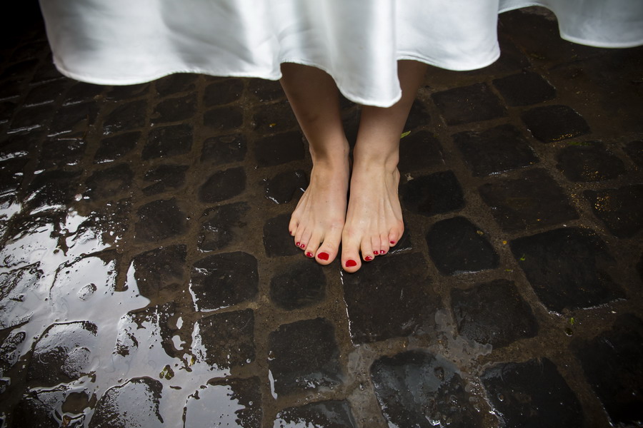 Bride's feet photographed over sampietrini in Rome Italy color vers