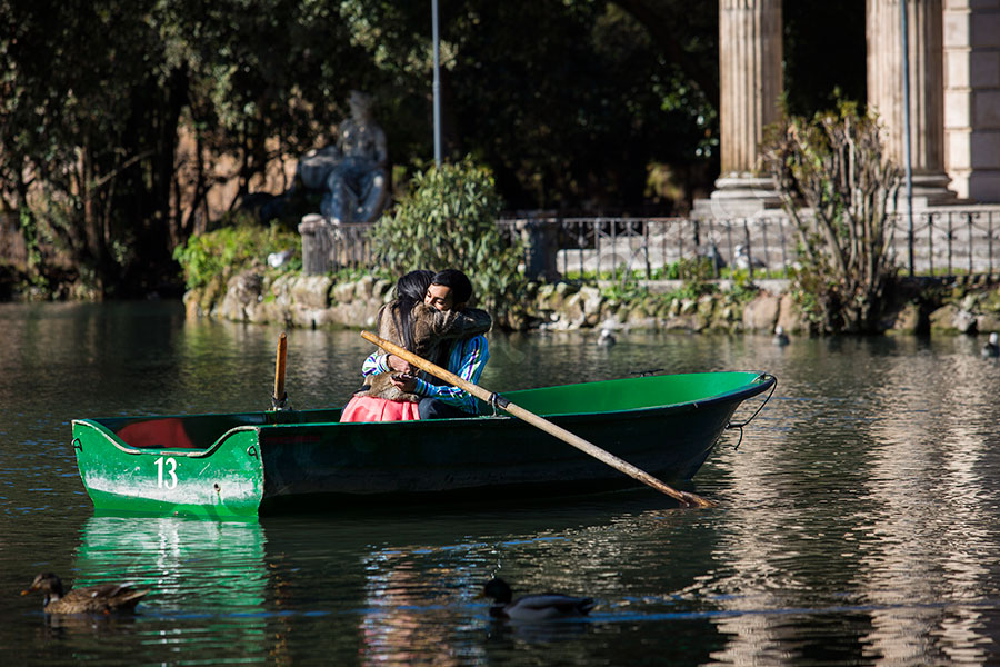 The joy and happiness after a surprise wedding proposal on an artificial lake in Villa Borghese Rome Italy