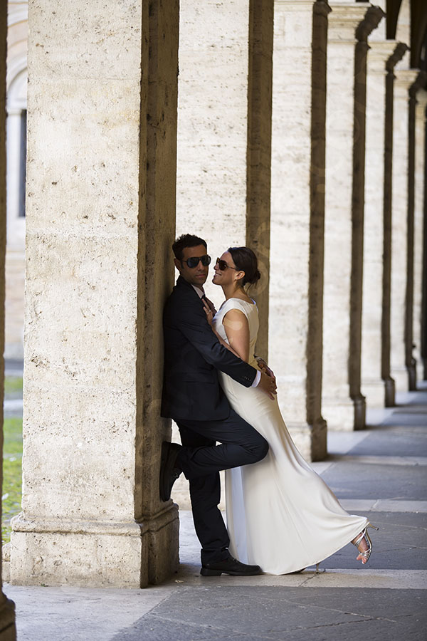 Just married couple by the columns.